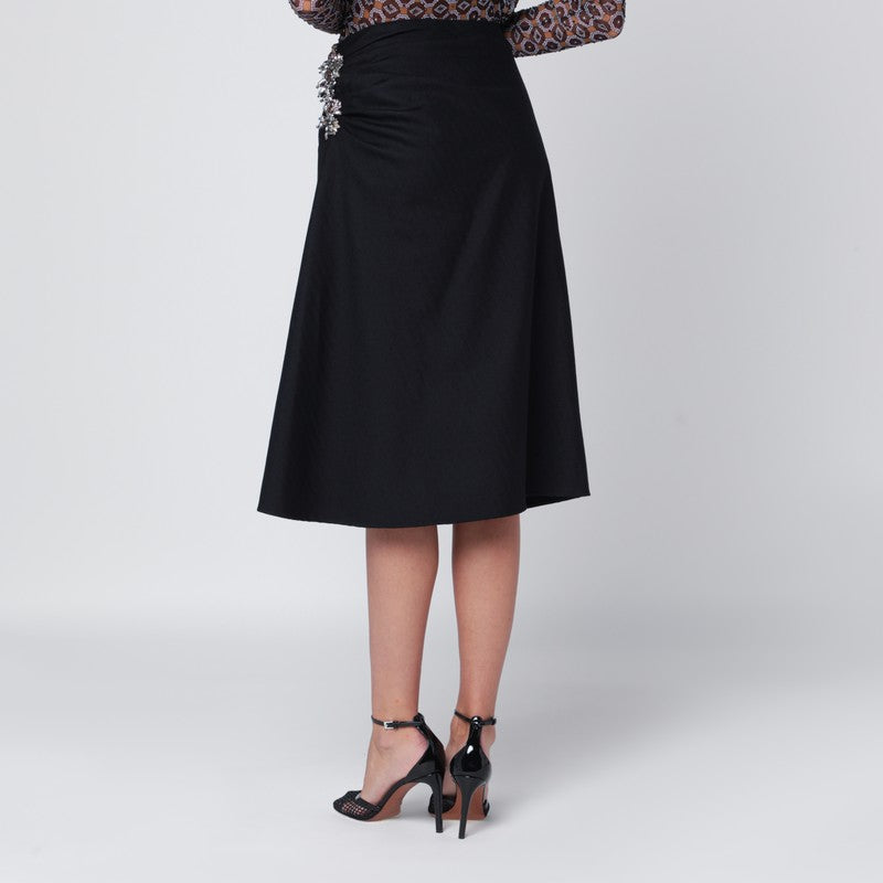 Navy blue draped skirt with brooch