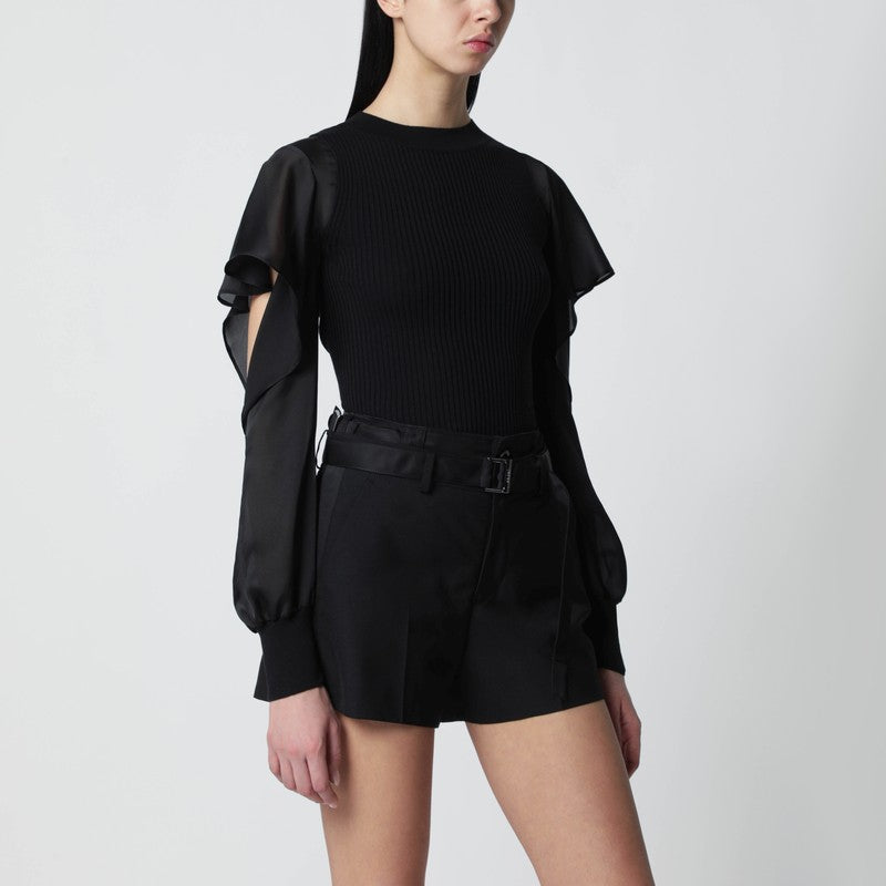 Black knit top with semi-sheer sleeves